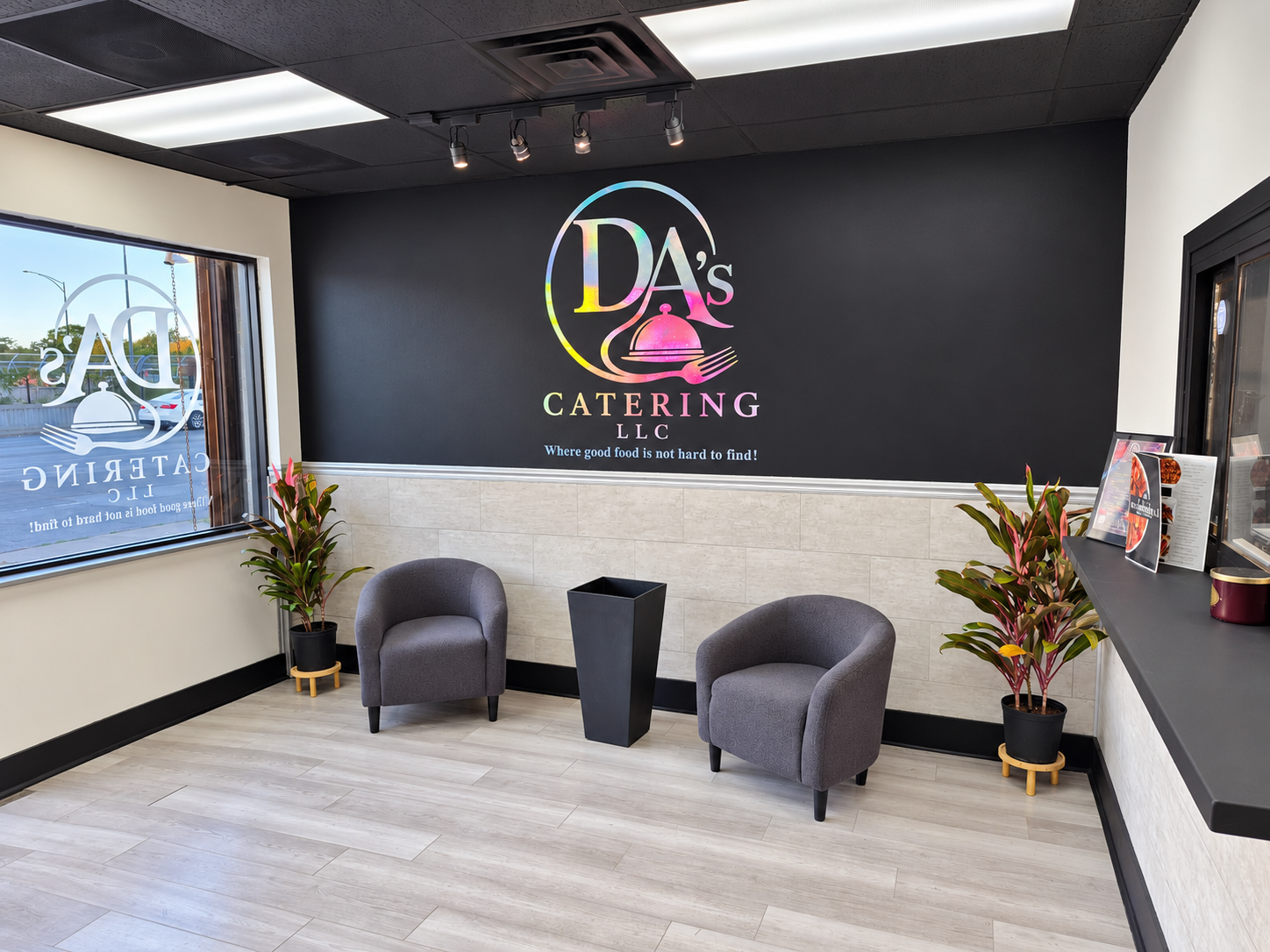 Lobby at DA's Catering featuring the company logo and seating area